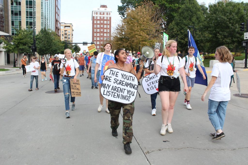 Veronica Cruz leads the mass of community members in rallying for climate justice.