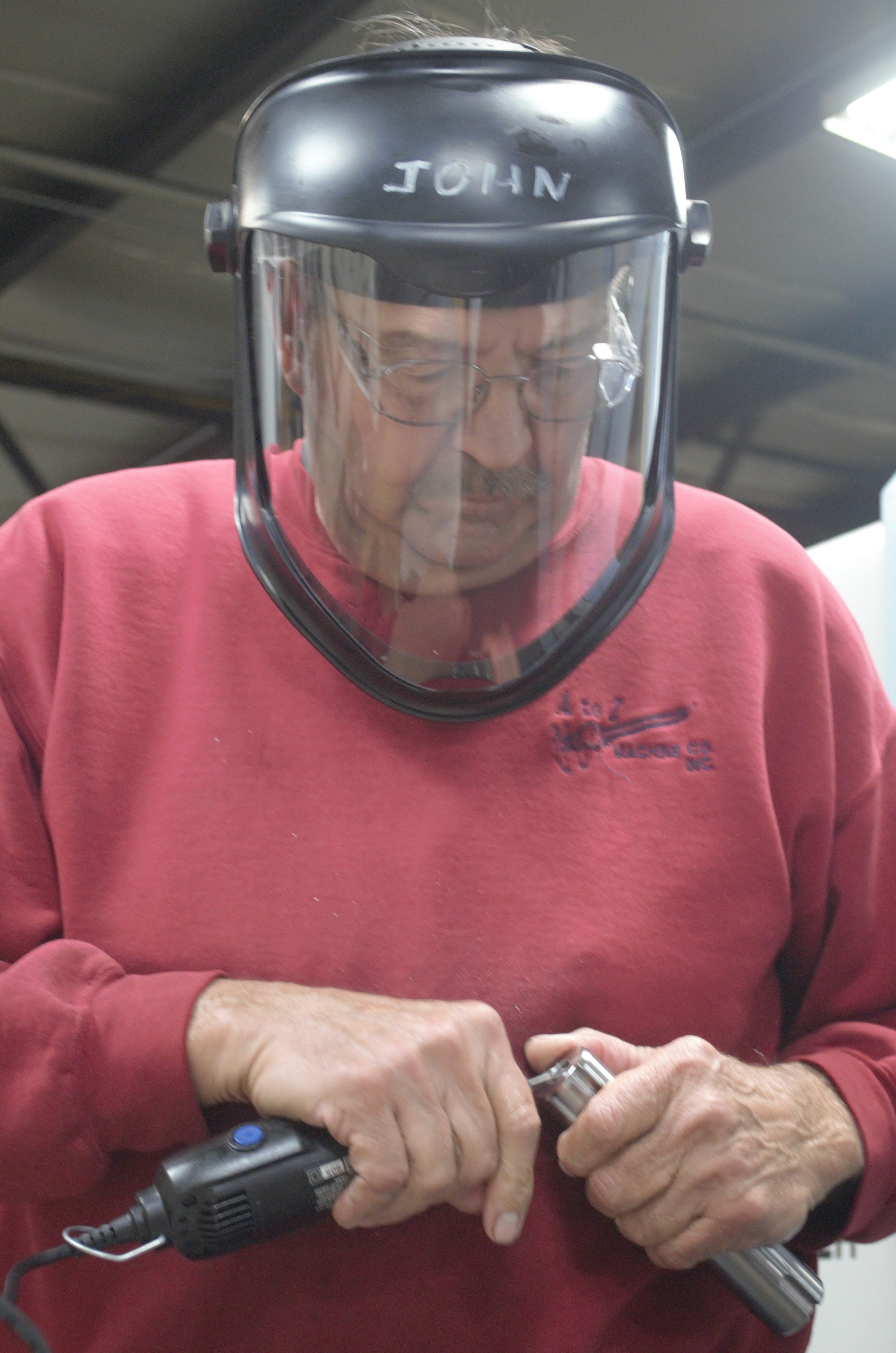 John Paider working on machinery